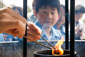 Lighting incense outside Tōdai-ji temple, Nara, Japan | © Matt Giraud Photography